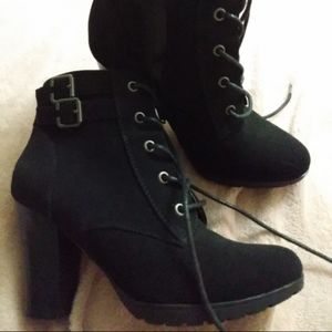 Black leather swayed zip up high heel boots